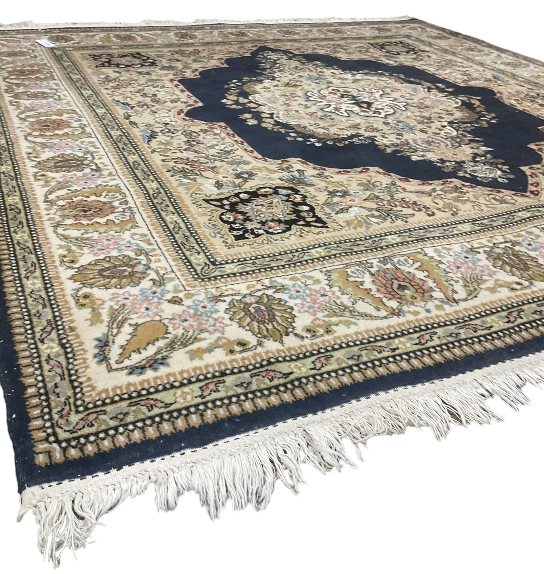 Persian Kirman indigo ground rug, central floral design medallion with matching spandrels, the guarded border decorated with stylised plant motifs 