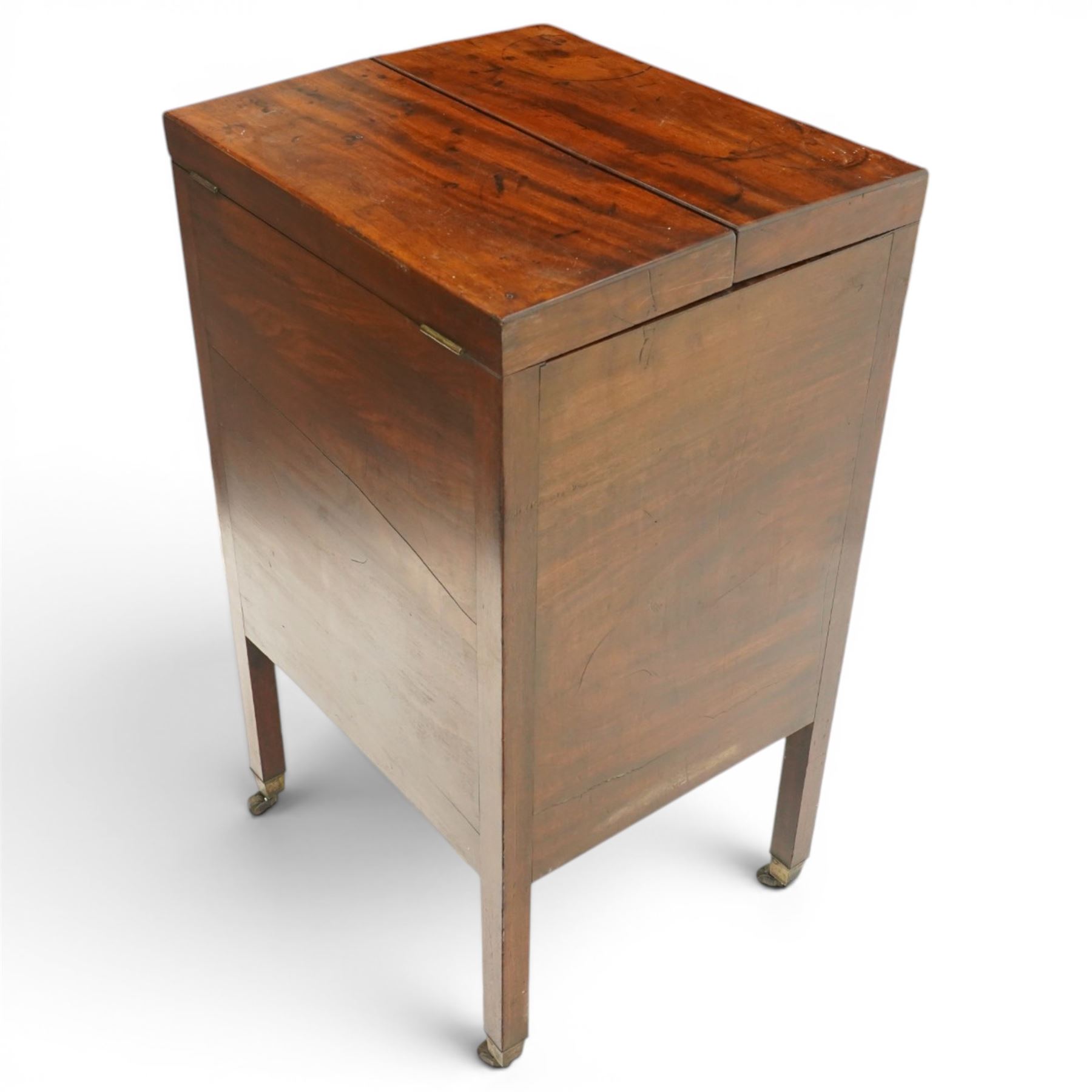 George III mahogany gentleman's washstand, rectangular double-hinged top enclosing fitted interior, over pot cupboard and two cock-beaded drawers, on square supports with castors
