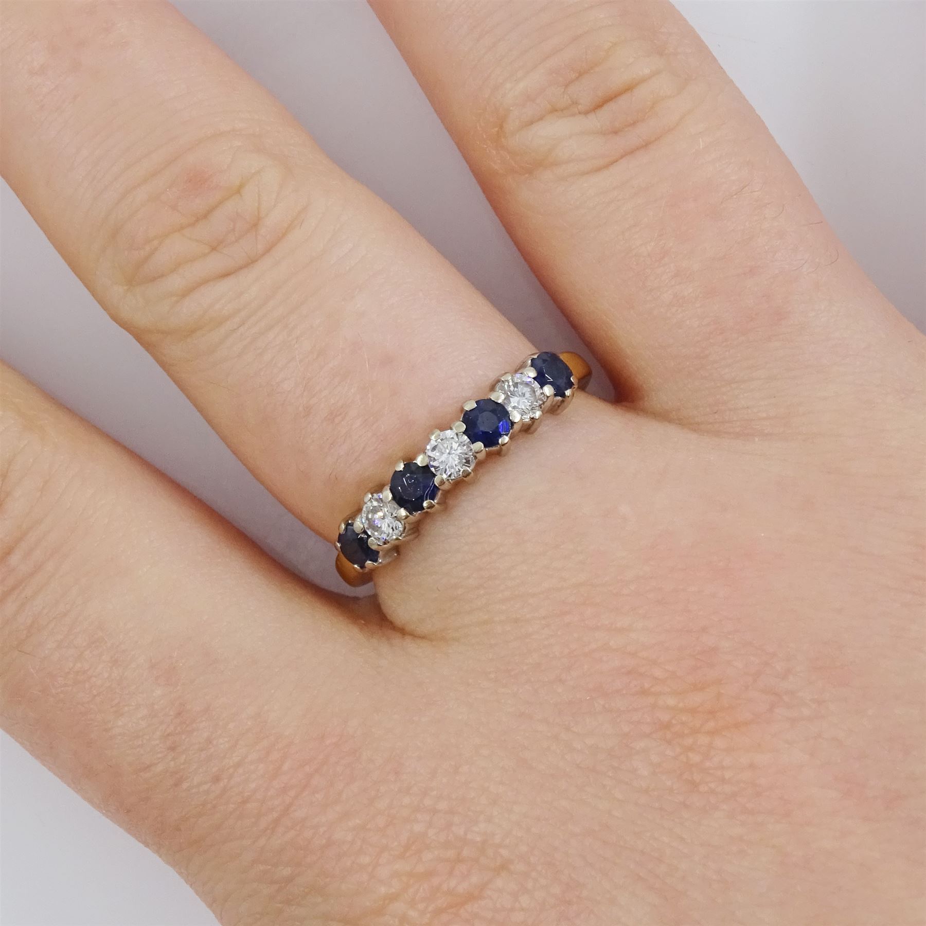 18ct gold sapphire and diamond half eternity ring, seven alternating round brilliant cut diamonds and round cut sapphires, hallmarked, total diamond weight approx 0.30 carat