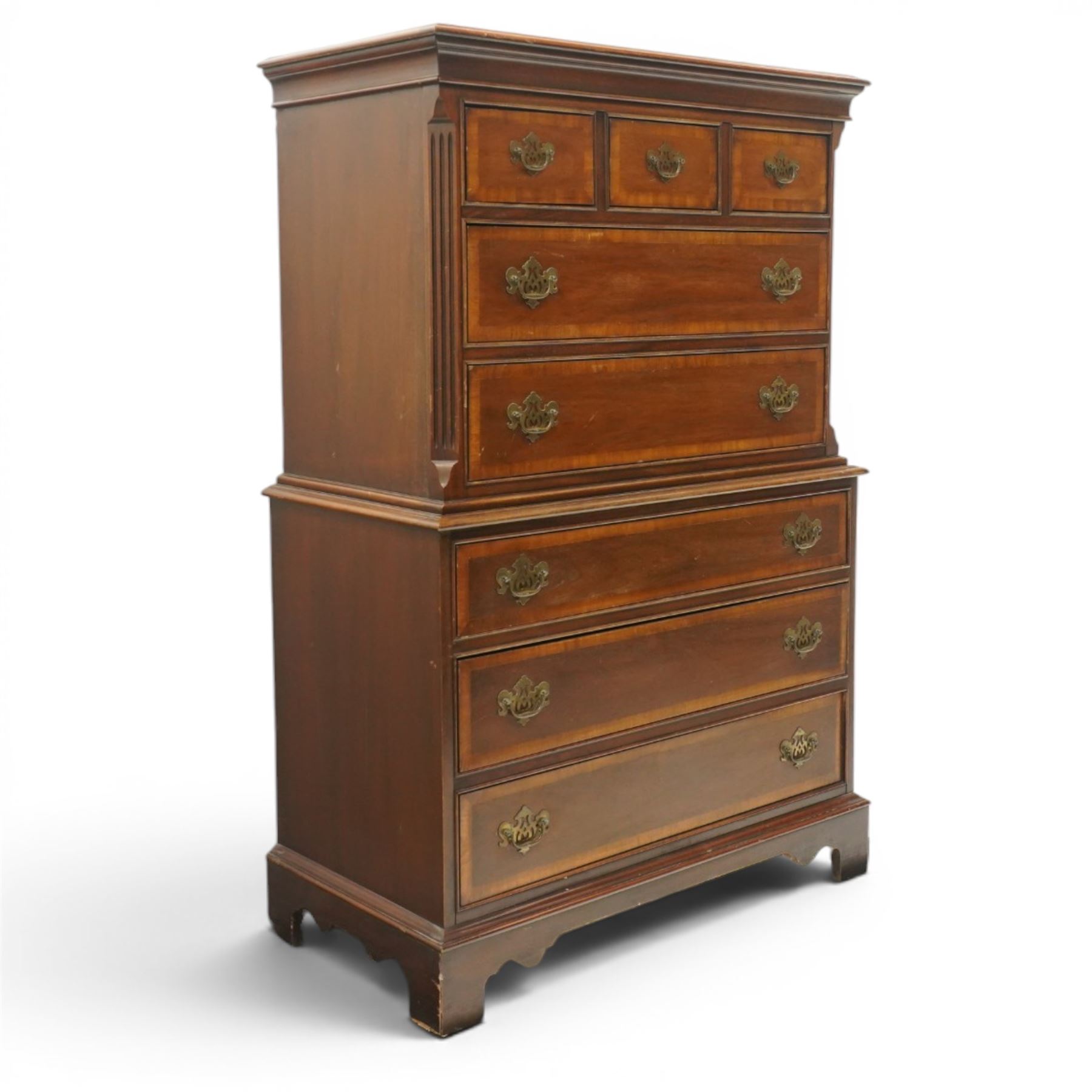 Georgian design mahogany chest on chest, moulded projecting cornice over three short and two long drawers, canted fluted front corners, lower section fitted with three long drawers, brass pierced backplate handles and escutcheons, on shaped bracket feet