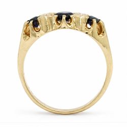 Gold sapphire and diamond ring, three round cut sapphires spaced by four single cut diamond accents, stamped 18ct