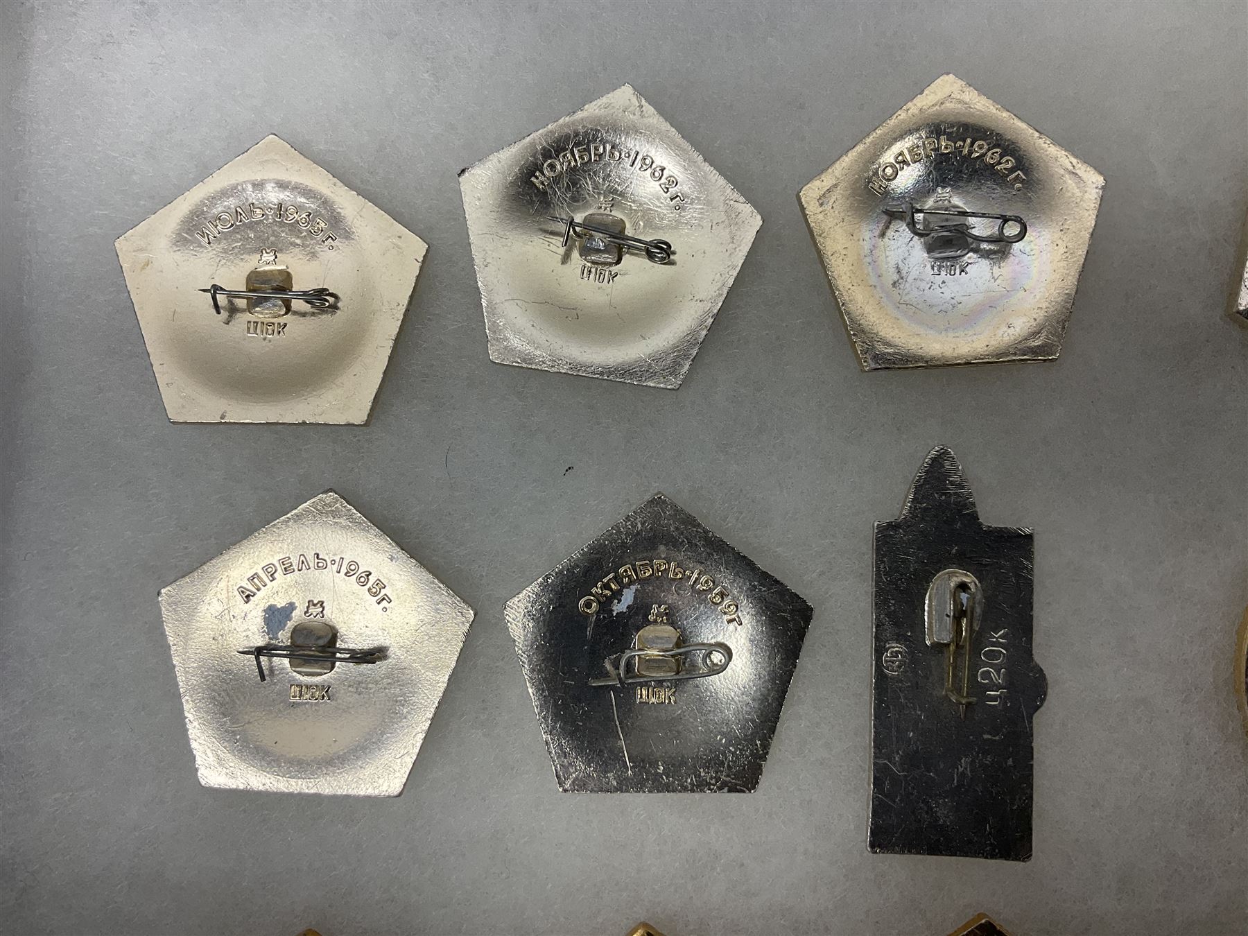 Twenty-six Russian Soviet Space badges 1960s/70s; in small display case