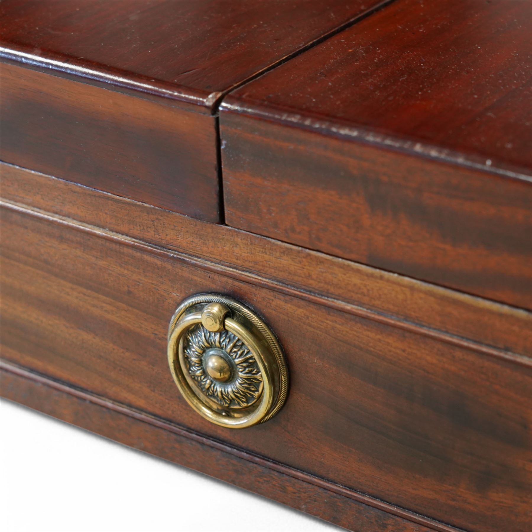 Early 19th century and later mahogany washstand, the dual-hinged fold-out top, over a cupboard enclosed by tambour roll, fitted with deep drawer to base disguised as two cock-beaded drawers, on splayed supports