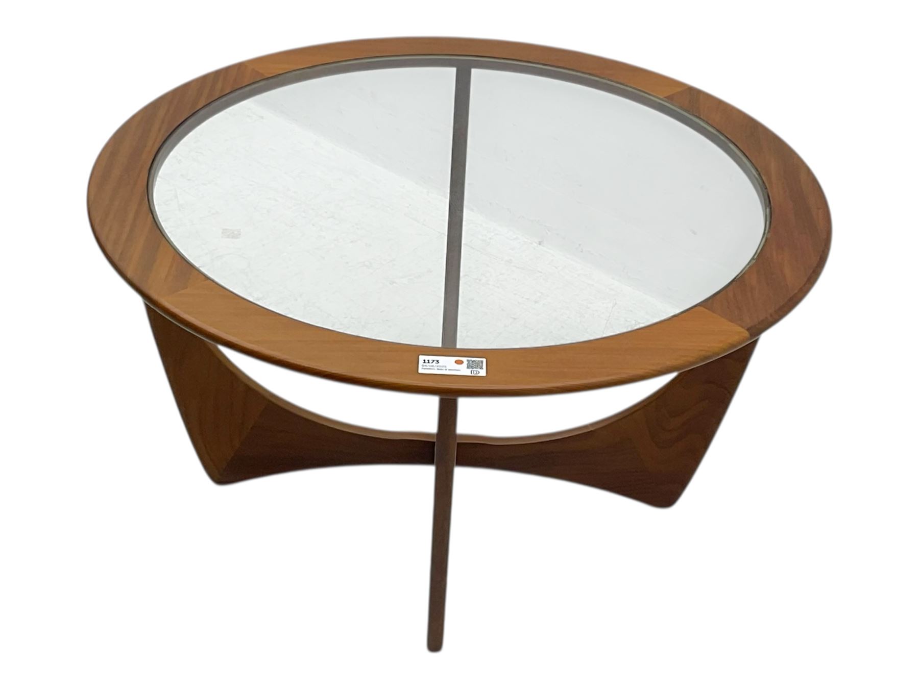 G Plan - Mid-century teak coffee table, circular form with inset glass top within a wide chamfered teak border, on sculptural cruciform base with curved intersecting supports