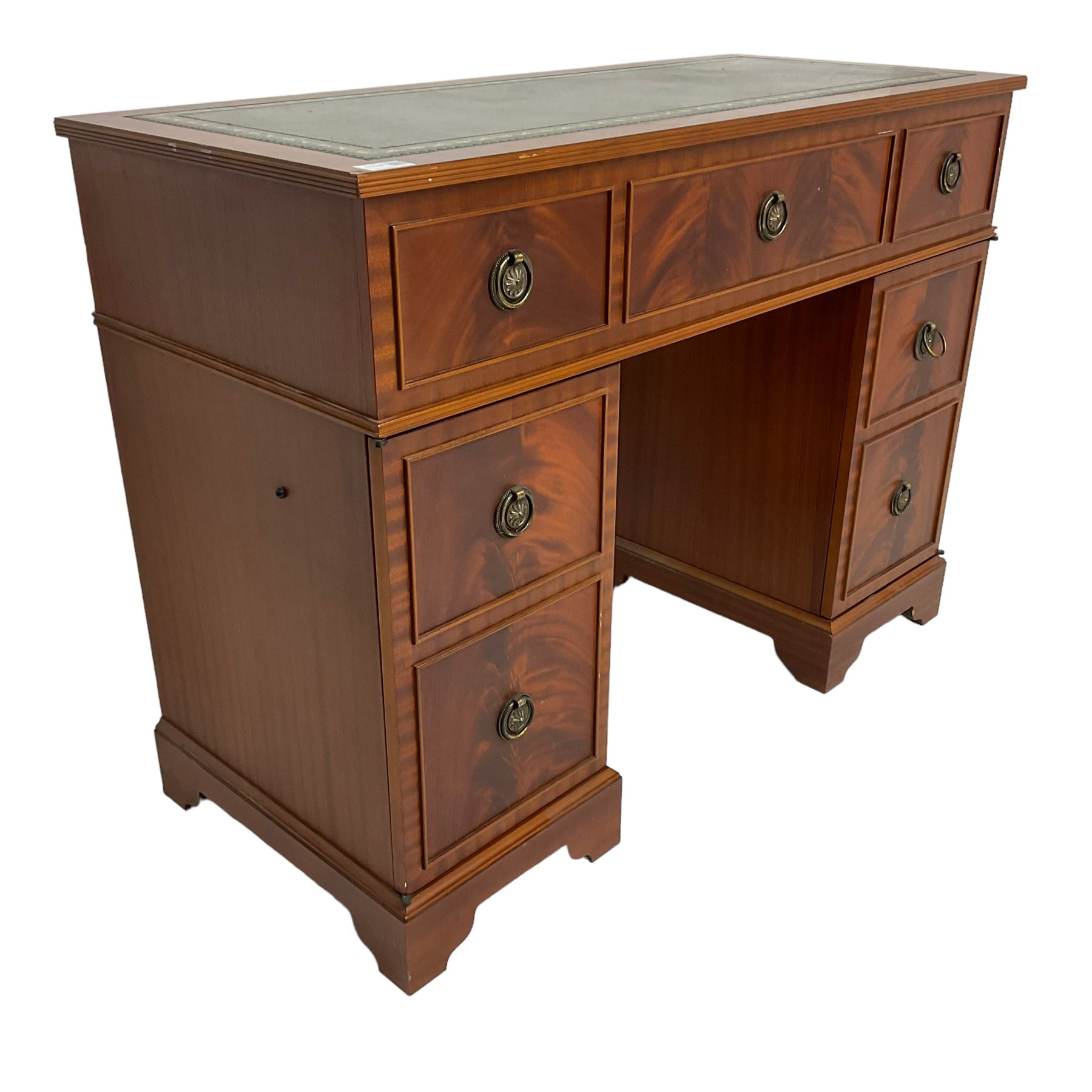 Music system in the form of a Georgian design twin pedestal desk, the reed moulded rectangular top hinges to reveal Garrard turntable with Dynatron Amplifier, fitted with speakers enclosed by two doors disguised as drawers, on bracket feet