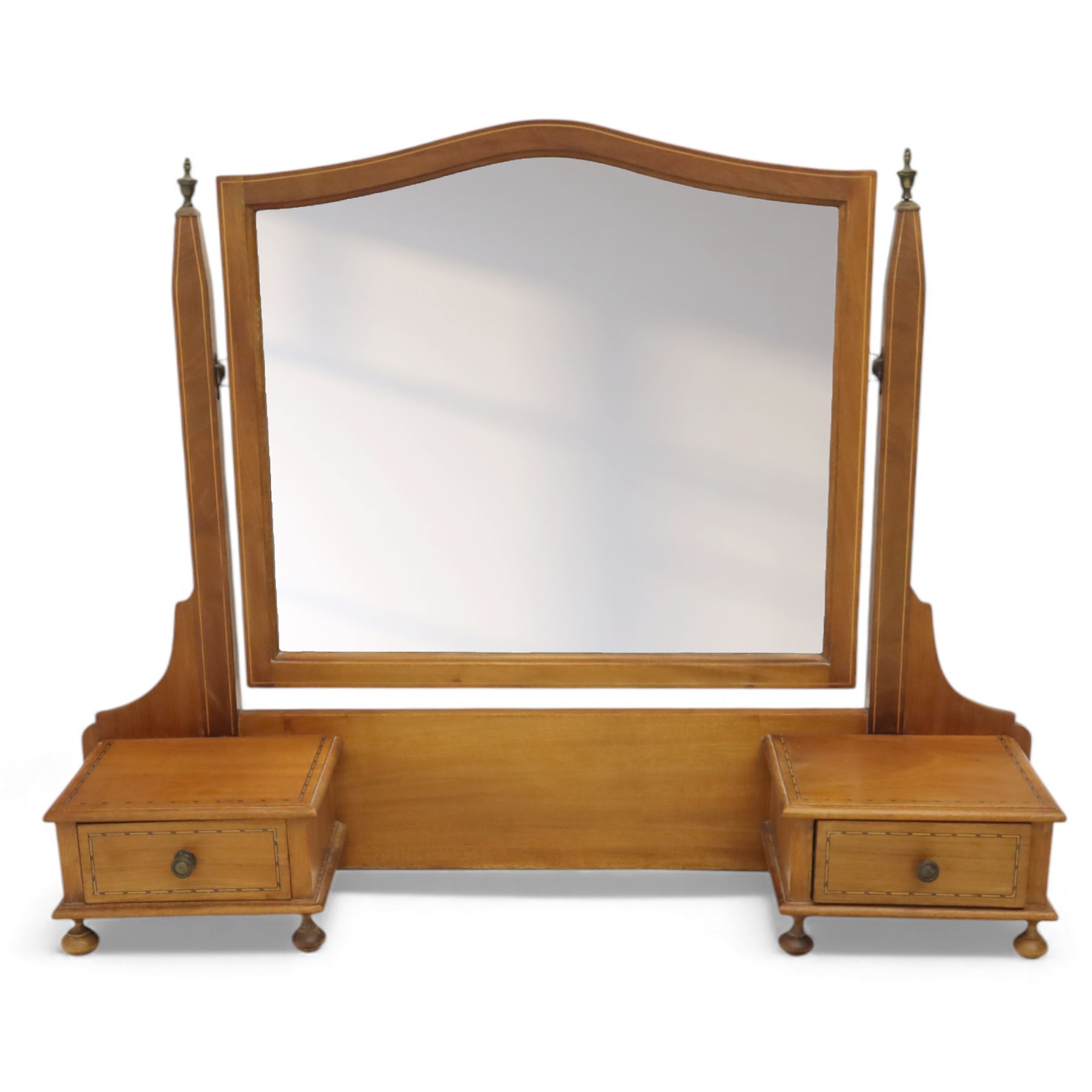 Two early 20th century mahogany swing dressing mirrors, comprising one with arched rectangular plate in a moulded frame on shaped supports, flanked by two inlaid trinket drawers (H 69cm, W 88cm, D 20cm), together with another rectangular plate mirror on turned supports upon bun feet (H 58cm, W 48cm, D 23cm)