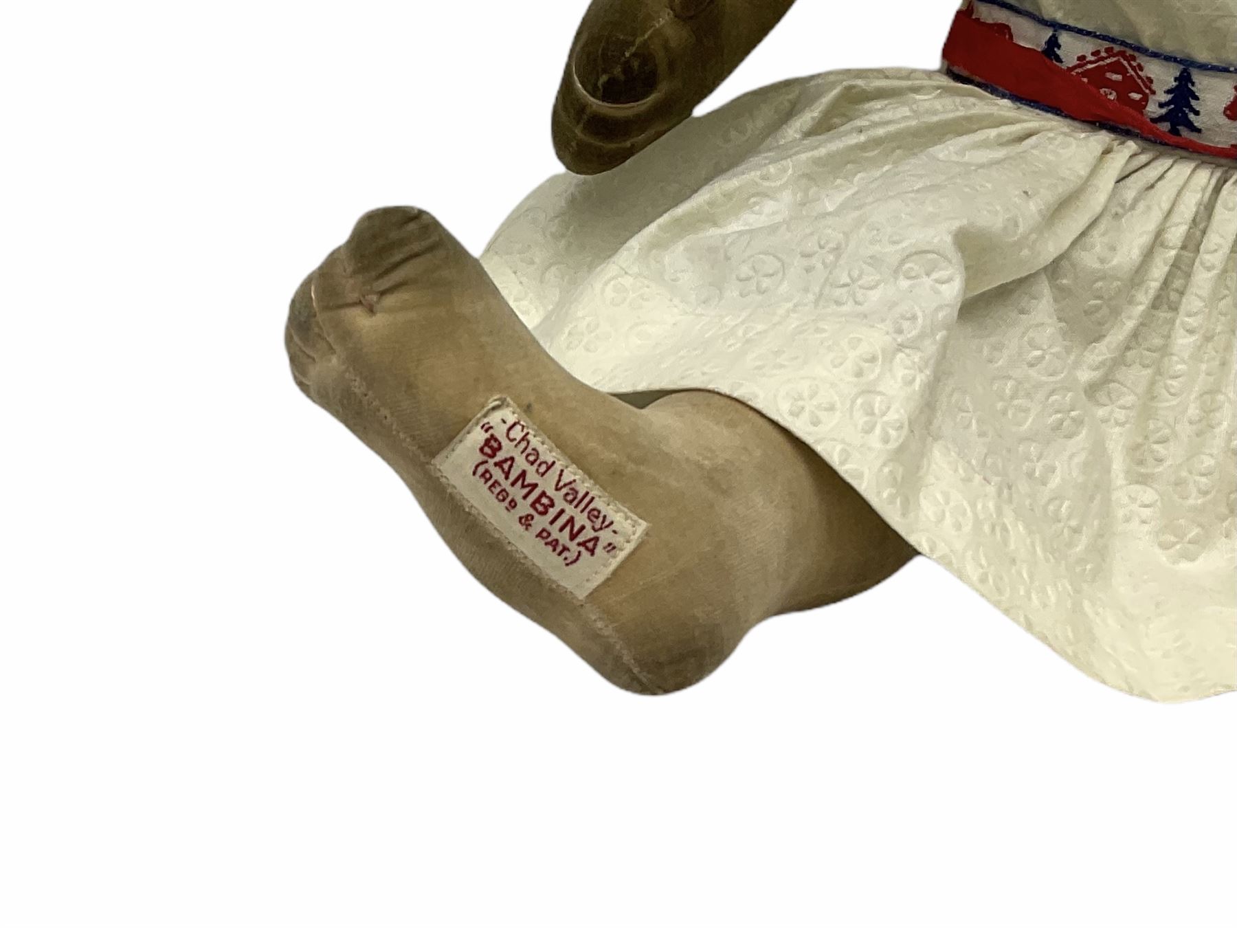 1920s Chad Valley 'Bambina' doll, the pressed felt head with applied hair, side glancing inset glass eyes, painted facial features and velvet jointed body, Hygenic and Bambina labels to the feet H46cm