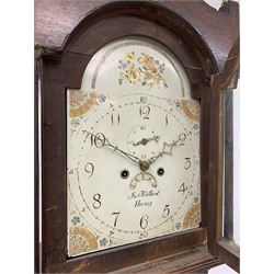 Early 19th century oak longcase clock, shaped pediment over a stepped arch glazed door enclosed by plain pilasters, the case with canted corners and trunk door with sloped arch top and centre curved return, enamel Arabic dial painted with flowers and patterned spandrels, signed 'Jno. Hilbert, Haxby', eight-day movement with subsidiary seconds dial and false calendar dial 
