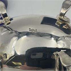 Modern silver plated three piece cruet set, comprising pepper shaker, open salt and mustard pot and cover, with two matching spoons, all of oval form with shaped rims and upon four pad feet, boxed