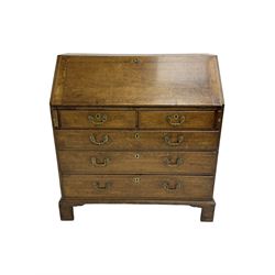 George III oak bureau, fitted with two short and three long drawers, on bracket feet