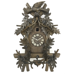  20th century Black Forest style Cuckoo clock, with carved acorn and bird cresting, Roman dial with twin weight movement, H59cm  