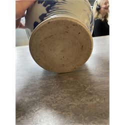 Pair of Chinese Kangxi blue and white porcelain vases, each of baluster form, painted with an outdoor scene containing figures seated upon the ground reading scrolls and holding fans, willow and bamboo tress, rock work and water, H27cm
