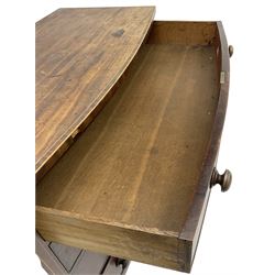 George III mahogany bow-front chest, crossbanded top with satinwood stringing, fitted with four graduating cock-beaded drawers, each with bone shield shaped escutcheons and turned handles, shaped apron flanked by splayed feet