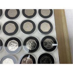 Thirty-seven commemorative fifty pence coins, including 2011 wrestling, other Olympics, Beatrix Potter etc, housed in capsules