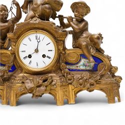French-late 19th century gilt and spelter mantle clock, highly decorative case with two Sevres style porcelain panels to the front and surmounted with three figures of children playing musical instruments, white enamel dial with Roman numerals and steel moon hands, two train countwheel strike movement, striking the hours and half hours on a bell. With key and pendulum.    