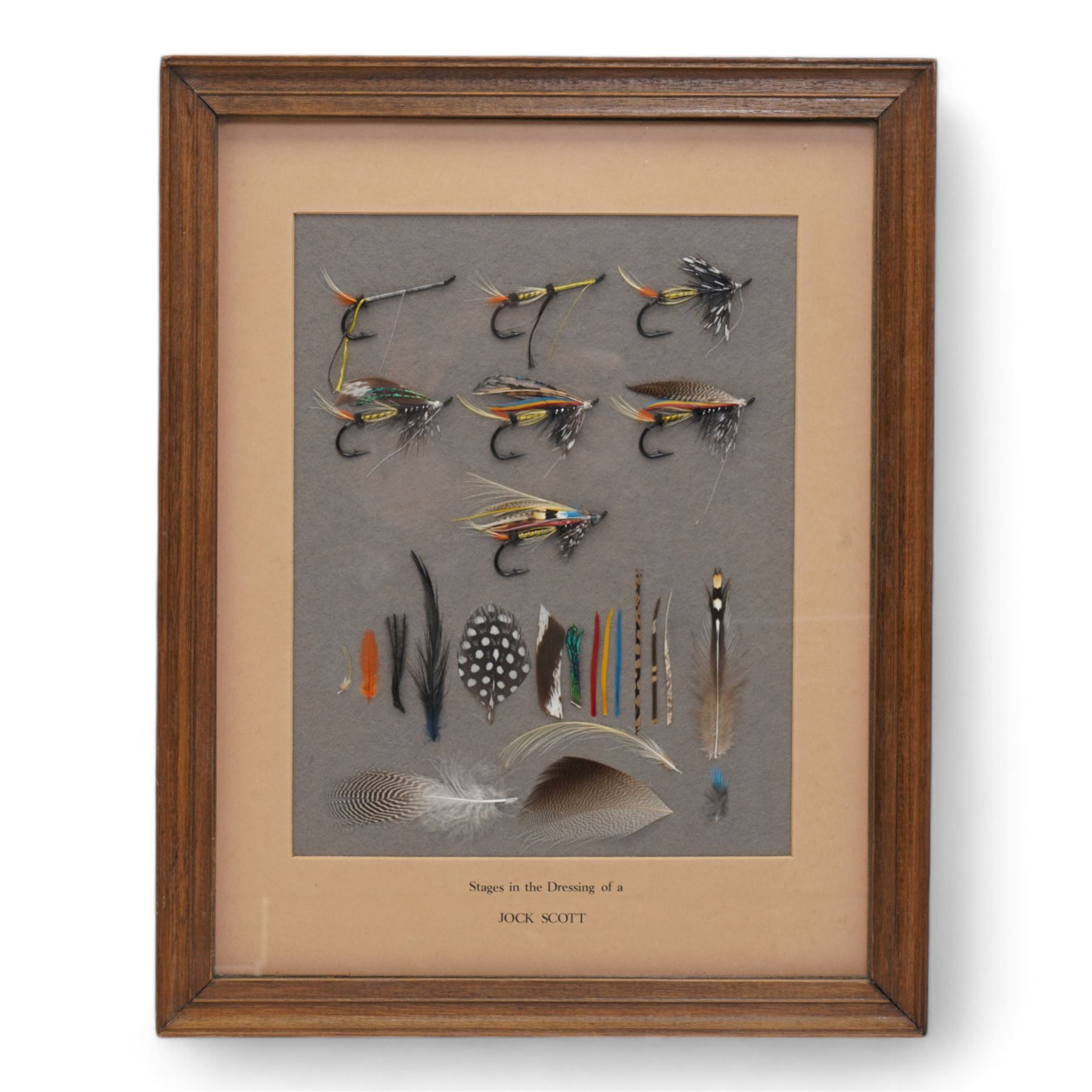 'Stages in the Dressing of a Jock Scott', a framed study showing the tying of a Jock Scott, circa 1980-81, the reverse hand-painted with the materials of the fly with handwritten instructions, the display was retailed by Dermot Wilson, Nether Wallop Mill and features as 'A new find' in their 1981 Farewell edition of A Choice of Tackle, Wilson retired in September 1981. The studies were created by a craftsman and his wife, the couple are not named and it's unknown how many others were produced, 37cm x 29cm overall