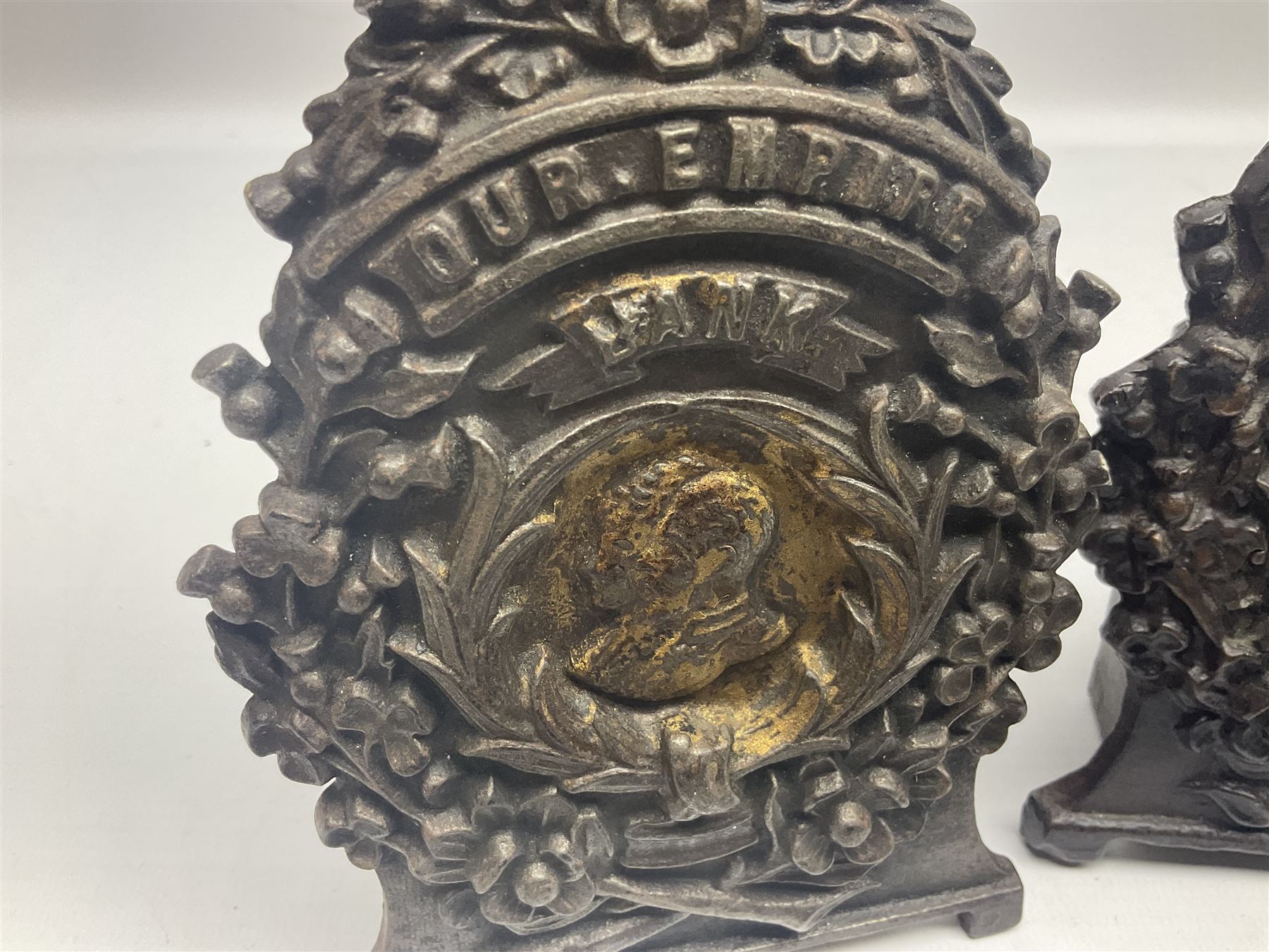 Two early 20th century cast-iron money banks - 'Our Kitchener Bank' c1914 H17cm and 'Our Empire Bank' c1911 depicting George V and Queen Mary H17cm; both by Sydenham & McCoustra; and another similar for The Prince & Princess of Wales 1981 by Robert Brown (3)