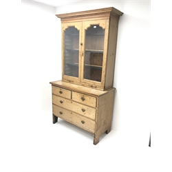 19th century pine cabinet on chest, projecting cornice, two doors enclosing three adjustable shelves, two slides above two short and two long drawers, shaped solid end supports, W108cm, H200cm, D54cm