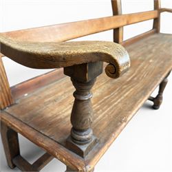 Early 20th century pine and oak bench seat, stained pine rail back frame with shaped oak arms