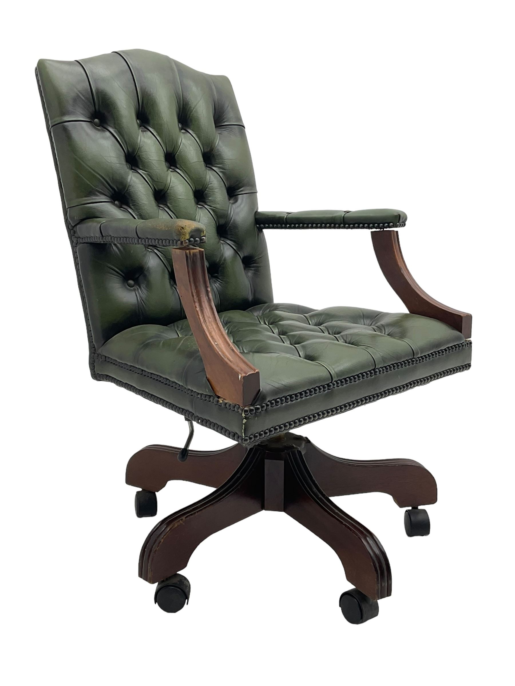 Georgian design swivel office desk chair, upholstered in buttoned green leather, on five spoke base with castors 