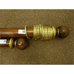  Medium wood and gilt circular curtain pole with round finials, with brass fittings and fourteen rings, L180cm and a matching pole with ten rings L120cm  