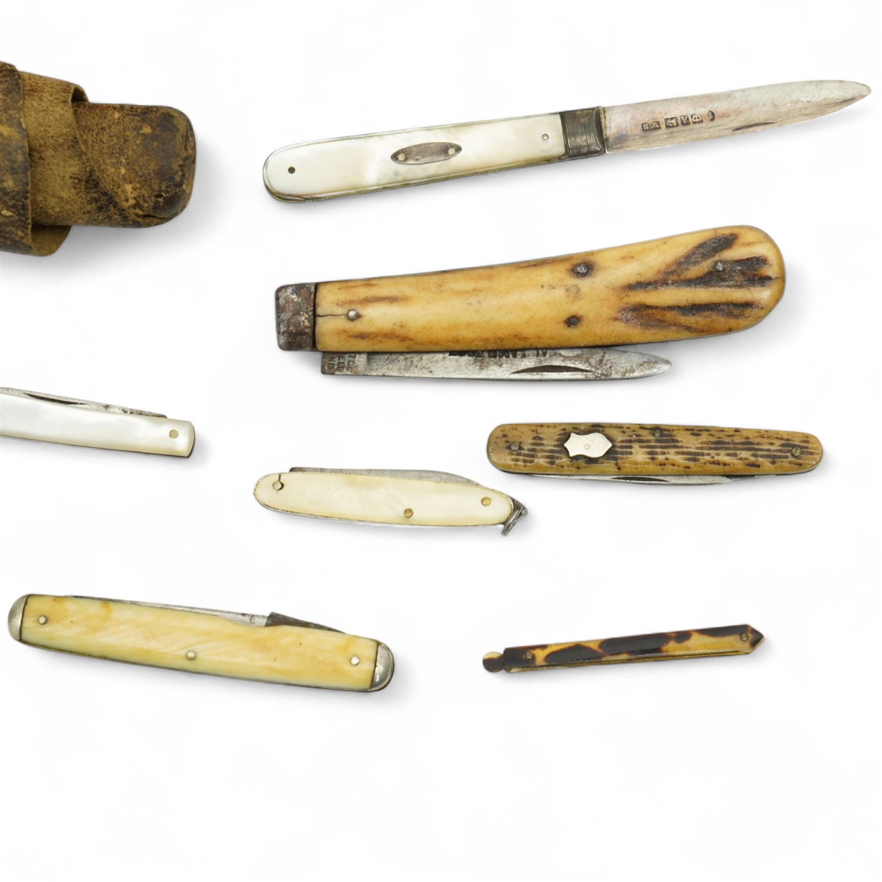 Two mother of pearl fruit knives with silver blades, 19th century pen knife with horn case by William Oates, Sheffield, another by Hunter, Sheffield, various other pen knives, cut throat razor by Barlow, Sheffield and a re-sharpening tool