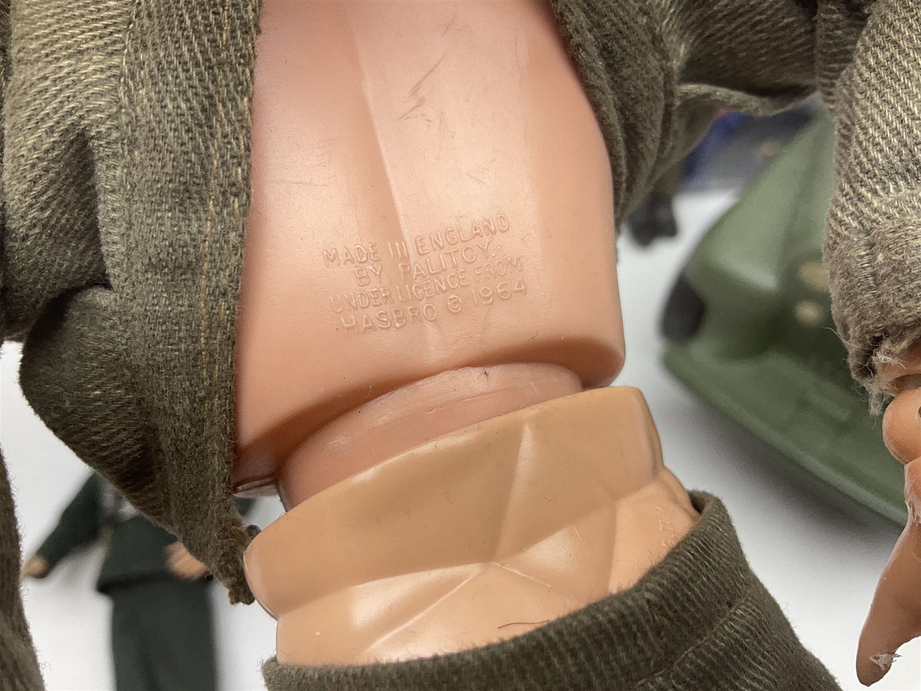 Action Man - five figures marked on the back 'Made in England by Palitoy under licence from Hasbro 1964', one dressed as a German Stormtrooper, one as a Red Devil Pilot and three in army uniform; another similar action figure marked to the right buttock ' G.I. Joe Copyright 1964 by Hasbro Patent Pending Made in Canada' dressed in army uniform; together with an Action Man jeep, field gun, mortar and machine guns and other accessories including helmets and weapons, parachute, diving equipment, skis and snow shoes, boots, uniforms etc; all unboxed