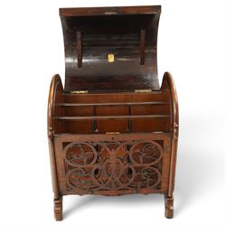 Victorian rosewood enclosed music Canterbury, the domed hinged cover enclosing a three-division interior, above a pierced scrolling foliate fretwork front panel, flanked by curved uprights and raised on scroll feet, hinged top applied with brass registration lozenge for 19 January 1860