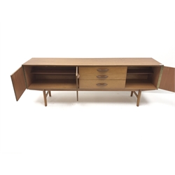  Mid 20th century Avalon teak sideboard, three graduating drawers flanked by three cupboards, tapering supports, W204cm, H72cm, D44cm  