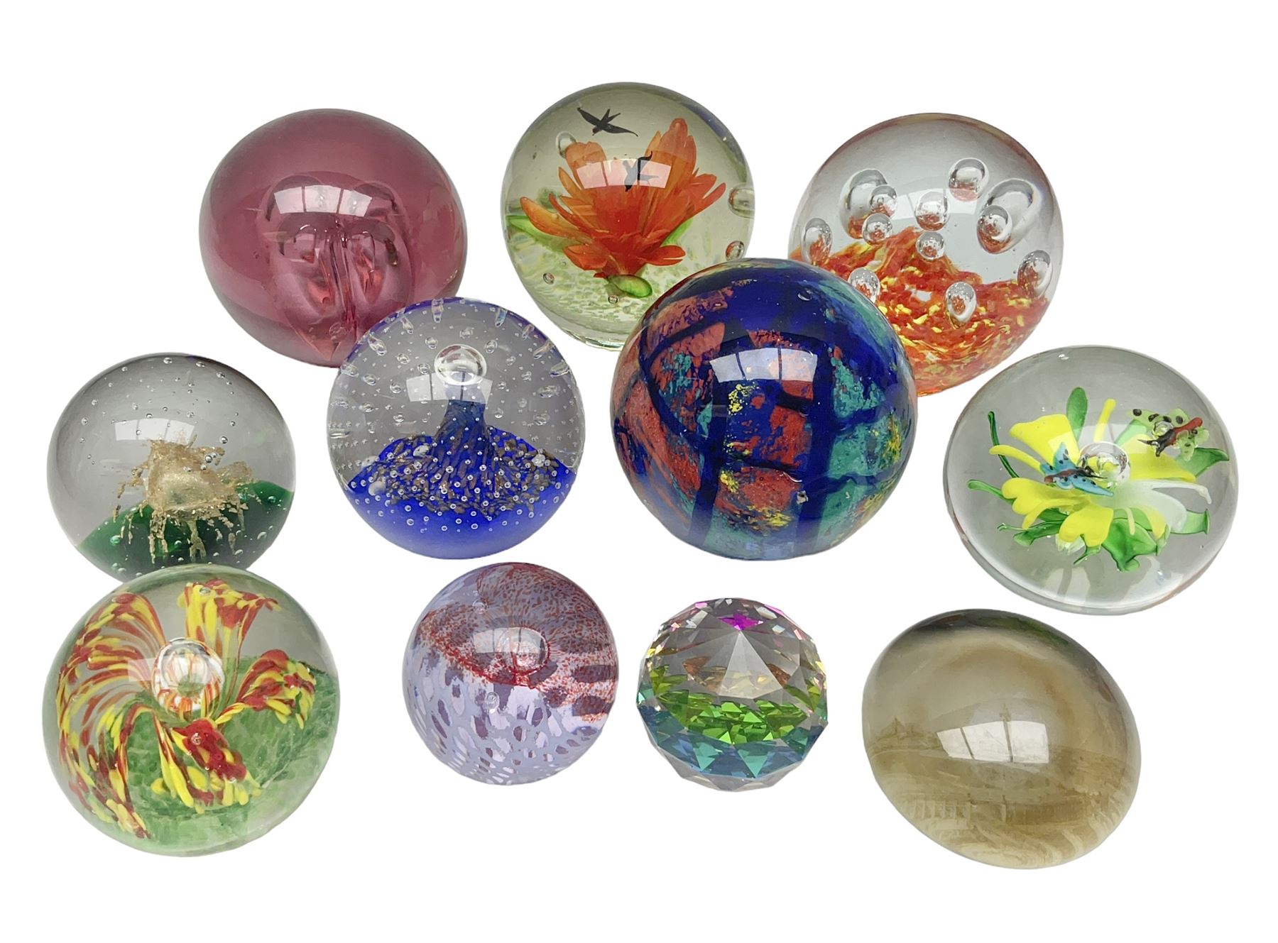Collection of glass paperweights, to includes examples with internal air bubble inclusions and ones with internal flowers (11)