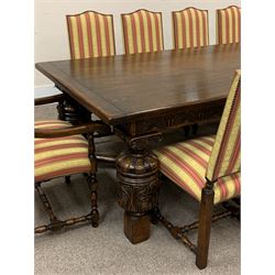 Royal Oak Furniture Co - Jacobean style oak dining table, rectangular top with a lunette carved frieze, acanthus carved baluster cup and cover supports joined by angular stretchers (276cm x 122cm, H81cm), and set ten (8+2) oak framed high back dining chairs upholstered in striped fabric with studded detail, turned supports and stretchers