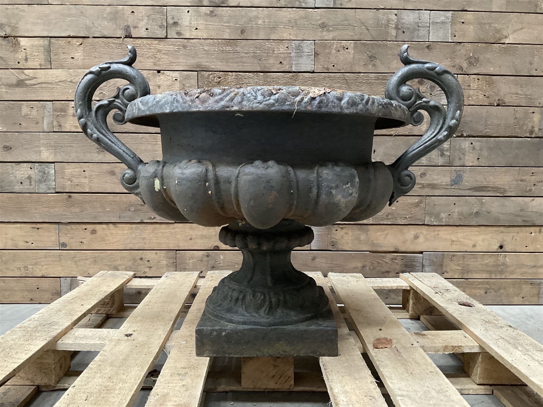 Victorian design ornate cast iron centrepiece urn, featuring two handles, raised on footed base