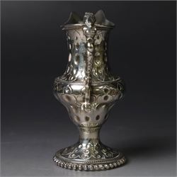 George III silver cream jug, of baluster form with hammered dimpling throughout and scroll handle, upon circular spreading foot with beaded edge, hallmarked Thomas Shepherd, London 1784, H10cm