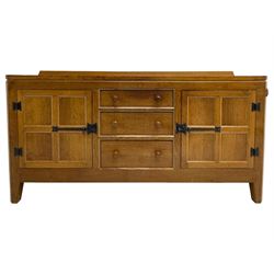 Rabbitman - adzed oak sideboard, fitted with three central drawer and two flanking cupboards, panelled doors with iron latches and hinges, carved with rabbit signature, by Peter Heap, Wetwang