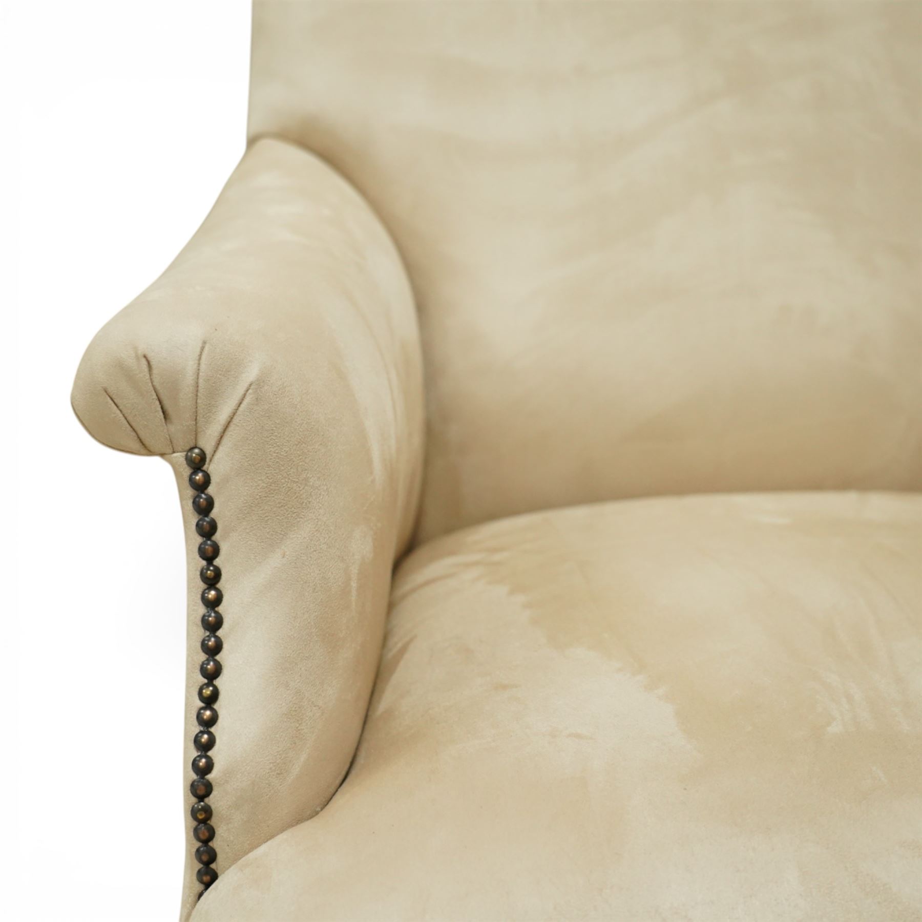 Sofas & Stuff - pair of ‘Thistle’ armchairs upholstered in neutral fabric, each with gently sloping back, padded scroll arms with close-set stud detailing, loose seat cushions, raised on turned wooden legs with brass castors