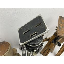 Three wooden adjustable tripods for plate cameras, together with a Linhof of Munchen metal tripod in a canvas case 