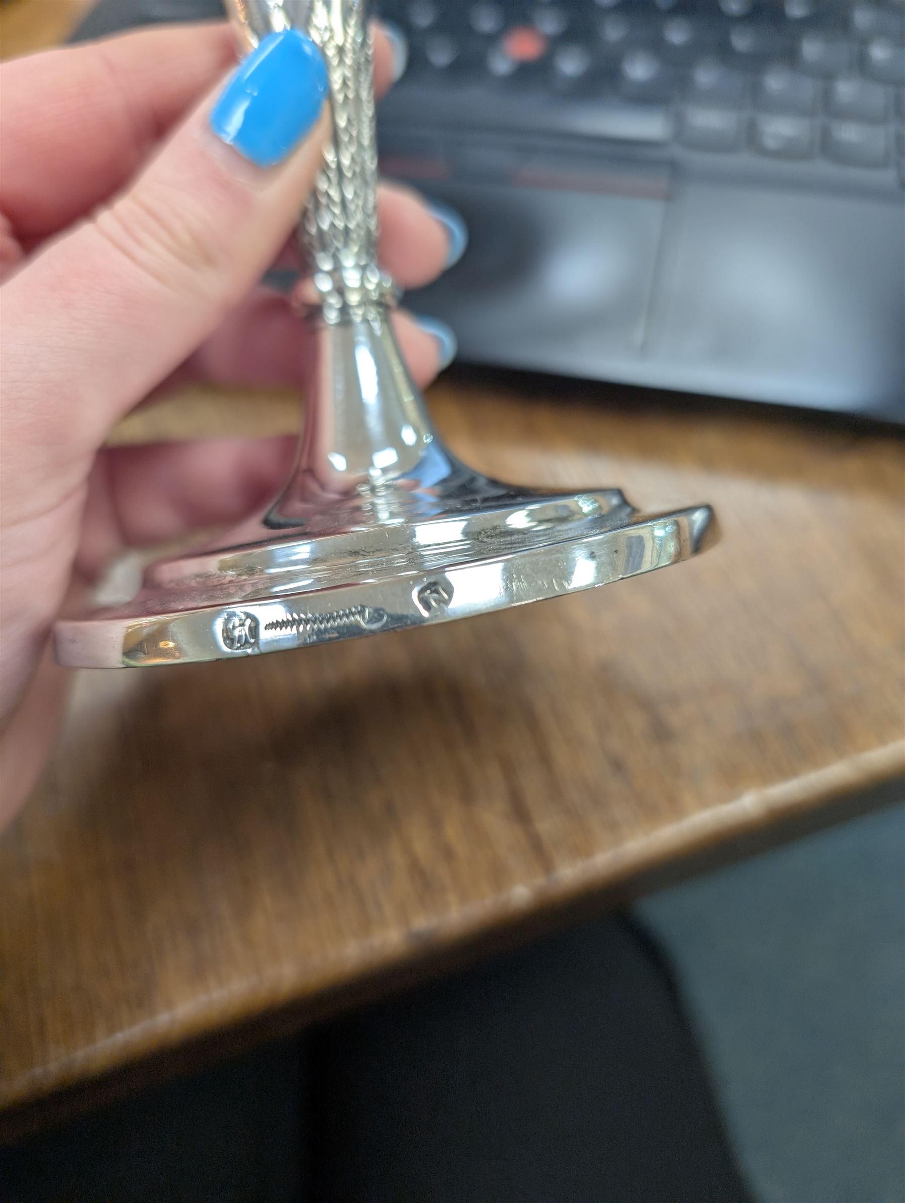 Pair of continental silver candlesticks, probably German Hanau, each of tapering form, with fern leaf decoration, upon a stepped circular base, with Hanau marks and assay scrape to base, H19cm