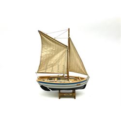 Wooden model of RMS Titanic, on a fixed black stand bearing plaque inscribed 'Titanic 1912', L54cm, H22cm, together with model of a sloop, gaff rigged on stand bearing plaque inscribed 'Sloop' L32cm, H42cm; and model of a fishing trawler on a stand bearing plaque inscribed 'Chalutier' L35cm, H28cm (3)