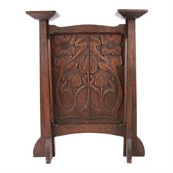 Art and Crafts carved  oak firescreen, the rectangular panel carved with Art Nouveau flowers and foliage, H84cm