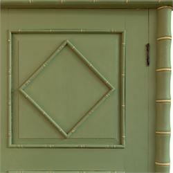 Regency design chinoiserie painted pine armoire, finished in sage green with carved simulated bamboo mouldings, projecting pediment with central lozenge panel, frieze decorated with small lozenges  surmounted by crossed finials, twin doors with diamond-shaped mouldings, interior with hanging cupboard, framed by full-length faux bamboo pilasters, above lower section with two short drawers on post feet 