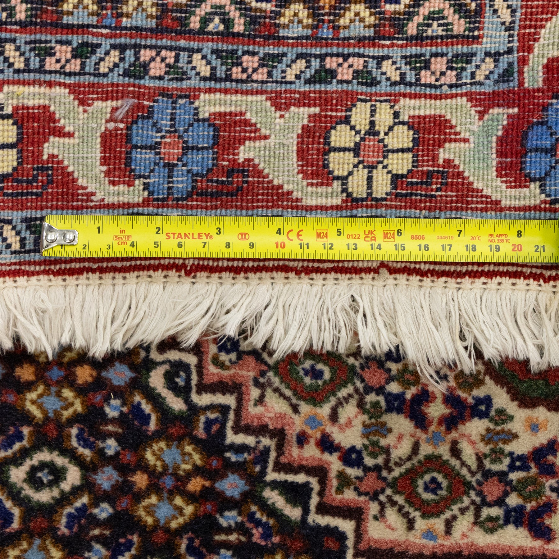 Persian Bijar prayer rug, dark brown ground with all-over Herati design surrounding a rust and pale blue central medallion, cream inner border and rust floral outer border