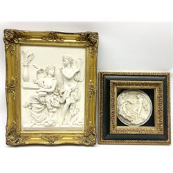 Composite marble effect plaque, moulded in high relief with two classical figures, in gilt frame, overall H51cm L40cm, together with another smaller example, the circular plaque also depicting a classical scene, in part gilded box frame, overall H34.5cm L34.5cm