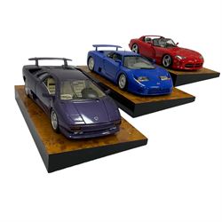 Three The Crestley Collection 1:18 scale model cars comprising Dodge Viper (1992), Lamborghini Diablo (1990) and Bugatti EB 110 (1991) mounted on heavy wood effect plinth bases, all with certificates