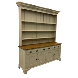 Victorian pine dresser, raised painted three heights plate rack with projecting cornice, waxed top over pained base fitted with three drawers and two double cupboards, bracket feet