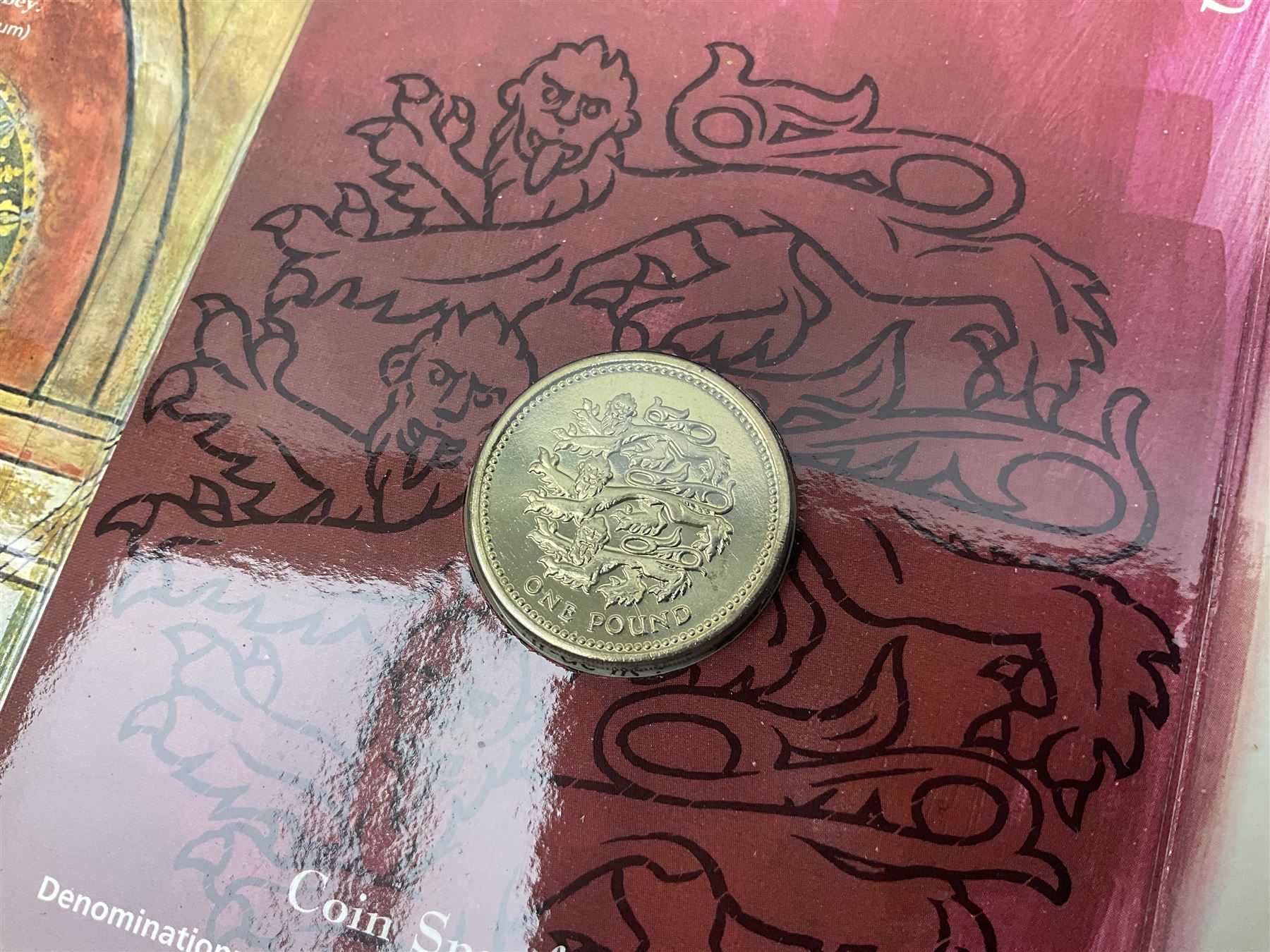 The Royal Mint United Kingdom 1984 brilliant uncirculated coin collection, 1997 and 2001 commemorative crown coins, 1997 old round one pound, all in card folders and four sterling silver medallic first day covers from the 'Great Britons' collection housed in a blue folder