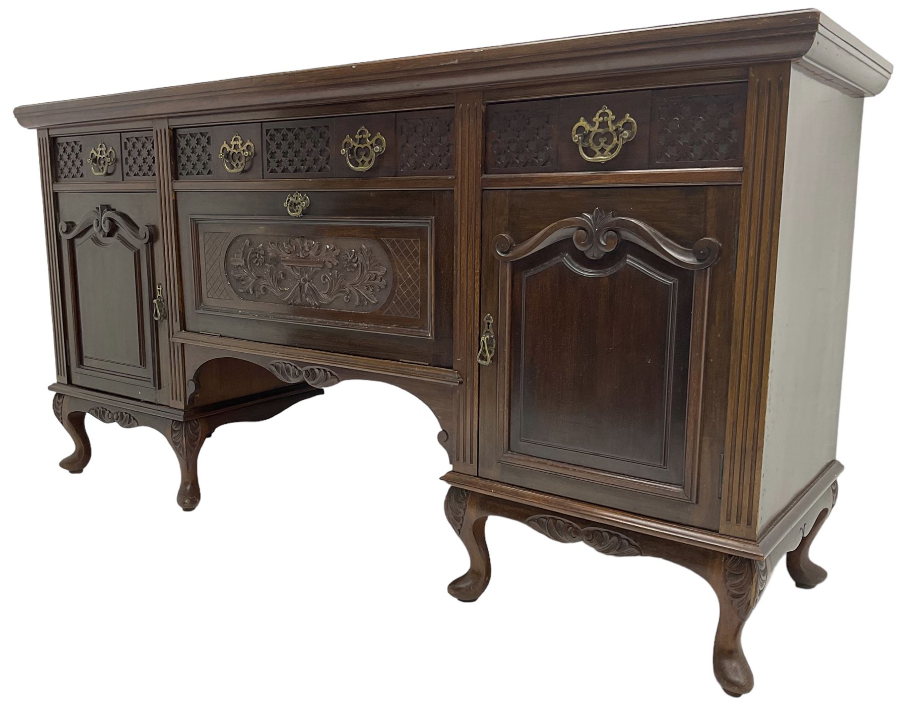 Late Victorian walnut sideboard, moulded rectangular top over three drawers  with blind fretwork facias, fitted with central fall front cupboard with extending foliage carved decoration and two flanking panelled cupboards, on acanthus carved cabriole feet