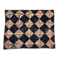 19th century log cabin pattern bedspread, worked with polychrome silks upon dark navy velvet ground, with orange geometric patterned lining to reverse, 140cm x 106cm