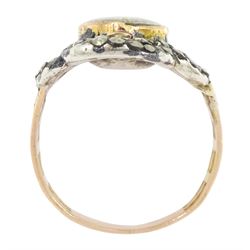 19th century gold and silver marcasite portrait ring, set with an oval miniature of a woman on ivory, under a glazed panel, with a marcasite and red stone set crossover surround, with pierced gold shoulders and reeded shank. This lot has been registered for sale under Section 10 of the APHA Ivory Act