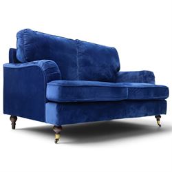 Howard design - two-seat sofa upholstered in blue fabric, traditional shape with rolled arms, on walnut finish turned feet with brushed metal cups and castors