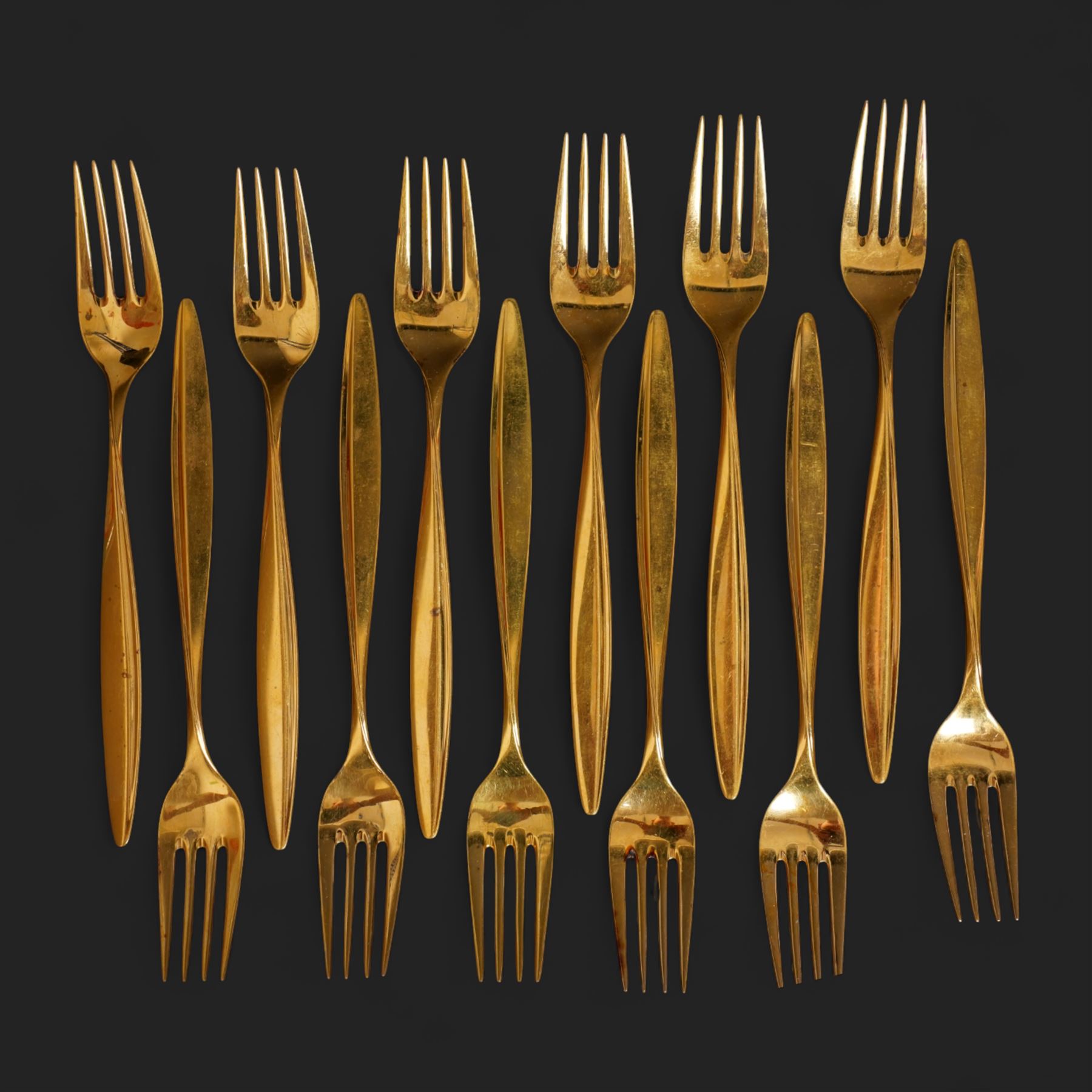 Extensive suite of WMF 800 silver gilt cutlery, for twelve covers, comprising twelve table knives and forks, fish knives and forks, dessert forks, table spoons, dessert spoons, teaspoons, eleven dessert forks and six serving spoons, with crescent moon and crown WMF hallmarks